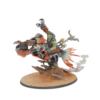3D model of a green-skinned Ork warrior riding a red and metallic warbike with a flaming exhaust, posed dynamically on a dese