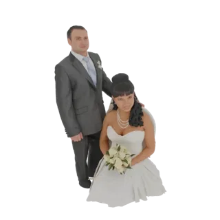 3D model of a wedding couple, with the bride kneeling in a white gown and holding roses, and the groom standing beside her in