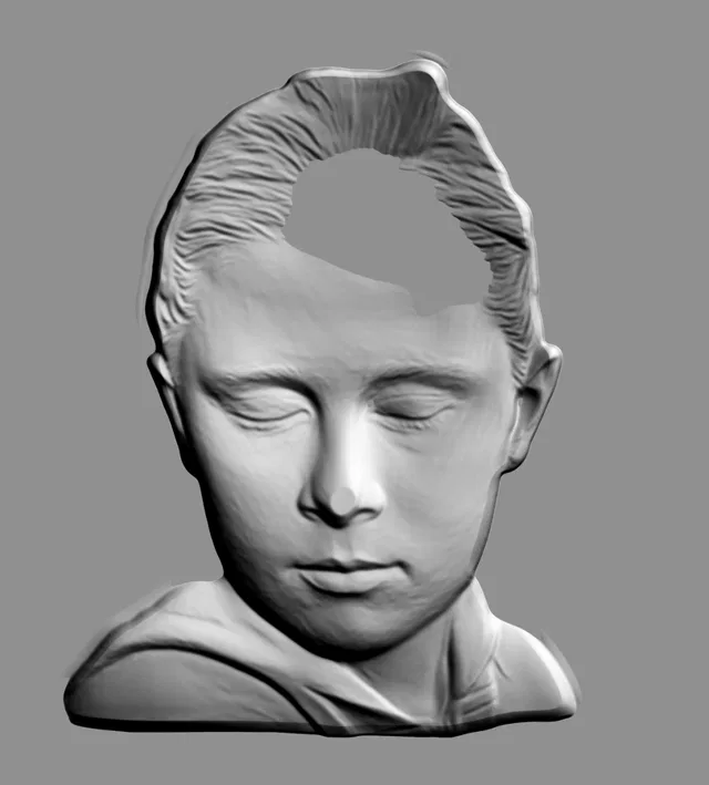 3D модель барельефа лица спящего ребенка в анфас, выполненного в виде медальона, с детальной проработкой черт лица.