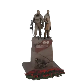 3D модель памятника ликвидаторам Чернобыля, показывающая две фигуры на скалистом основании с красно-зелеными лавоподобными эл