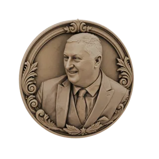 3D model of a circular bronze medallion featuring a relief portrait of a smiling man in a suit, surrounded by decorative scro