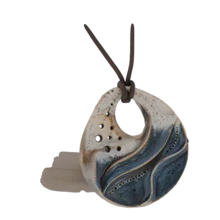3D model of an organic ceramic pendant with a blue wave design and a brown leather cord, set against a white background.