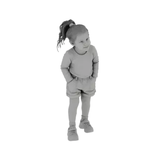 3D model of a young girl with a ponytail, wearing a long-sleeved shirt and shorts, standing with hands in pockets and looking